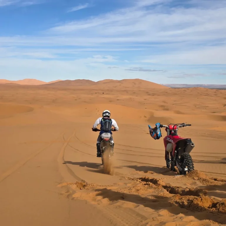 Enduro rider riding through soft sand tracks in the Erg Chebbi dunes