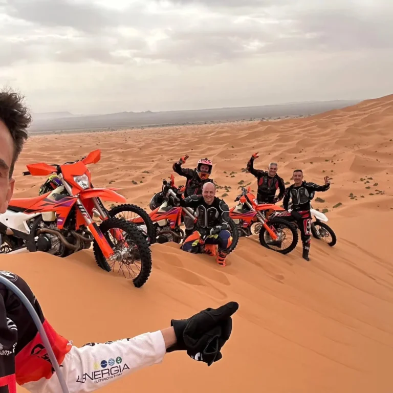 Group of enduro riders and KTM bikes in the Erg Chebbi dunes